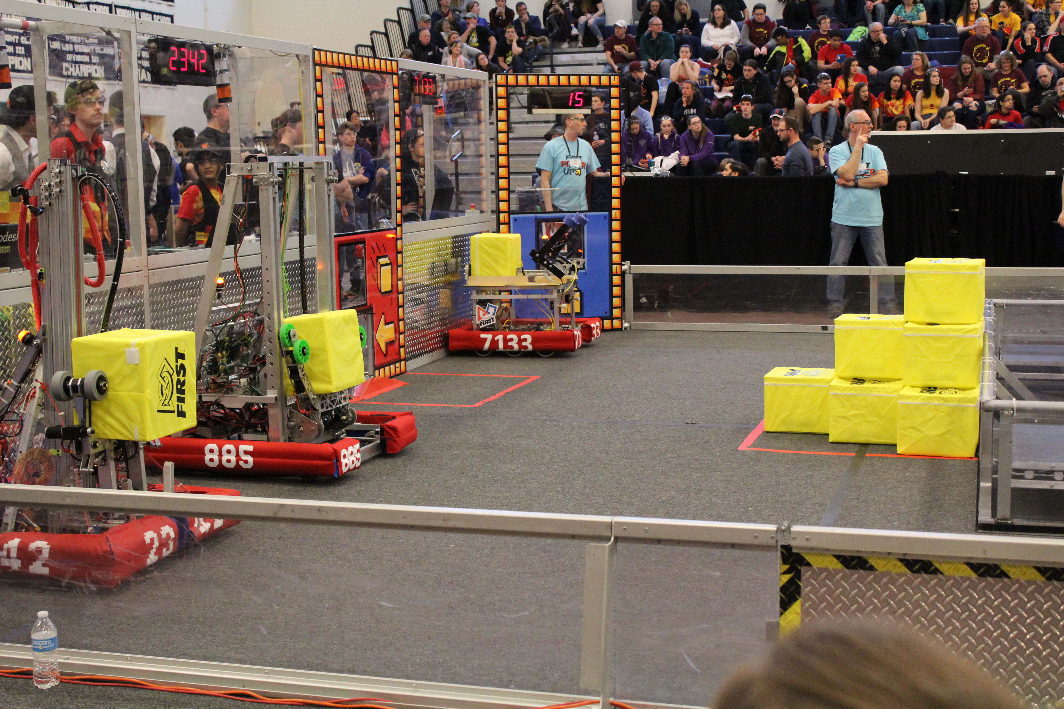 Robot On Field With Two Other Robots From Teams 885 And 2342 Waiting For A Match To Start